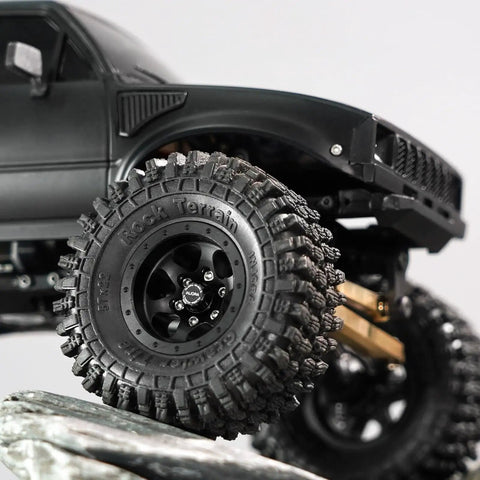 Close-up of M2 Wheel Lock Nuts With CNC Aluminum Cap for 1/24 RC Crawlers, fitted on a black tire, showing full nut coverage.
