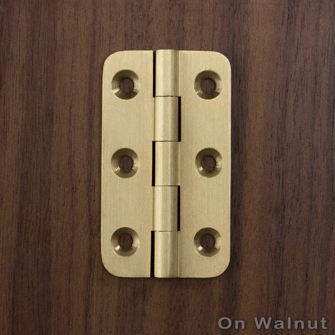 Built Tough 2 Inch Brushed Solid Brass Butt Hinges With Full Mounting Hardware For Heavy Lifting Door Installation Rust Resistant Smooth Swivel Action 4 Pack Set on wooden background.