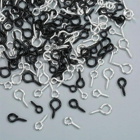 Must Have 300Pcs Small Screw Eye Pins For Jewelry Making And DIY Crafts in silver and black, three sizes scattered on a surface