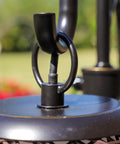 Detail of Castillo Outdoor Table Lamp in oil rubbed bronze with woven rattan shades, rustic two-light for Mediterranean style.