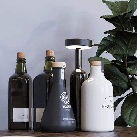 6 Pack USB Rechargeable Puck Lights With Remote For Under Cabinet Kitchen And Bedroom next to decorative bottles on a shelf