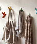 Set Of Six Slick Flying Bird Cast Iron Wall Hooks Featuring Hella Distressed Rustic Finish Decorative Mounted Hanging Hardware with bags and towels.