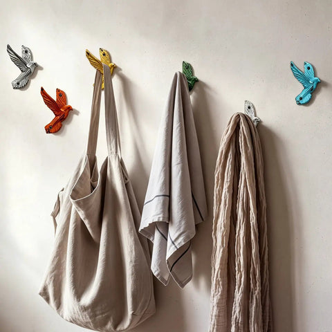 Set Of Six Slick Flying Bird Cast Iron Wall Hooks Featuring Hella Distressed Rustic Finish Decorative Mounted Hanging Hardware with bags and towels.