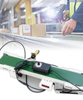 Smooth Operator Mini Desktop Conveyor Belt With Quick Gear Tuning And Heavy Duty DC Motor Hauls Up To Eleven Pounds Without Breaking A Sweat For Fast Packing Shifts on a table with a package and scanner.