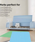 Four 12x12 inch Cricut cutting mats (LightGrip, StandardGrip, StrongGrip, FabricGrip) with blue Cricut Maker on desk.