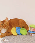 Universal Silicone Can Lids For Dog And Cat Food, 3 Pack With Spoon, Multi Colored Set next to a cat and canned pet food