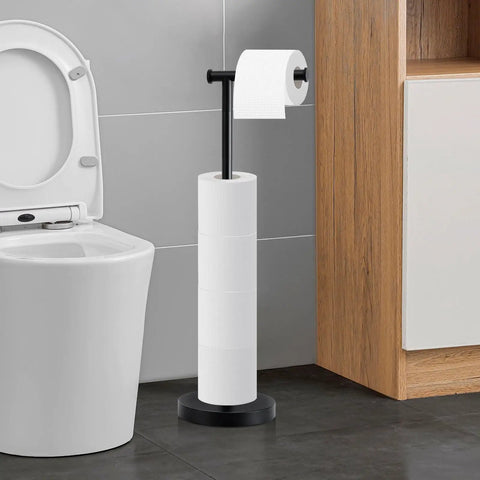 Stand-alone toilet paper holder with multiple rolls, matte black metallic finish, next to a toilet in modern bathroom setting.
