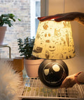 Nightmare Before Christmas Jack Skellington Table Lamp LED Light For Bedroom And Living Room on a desk with Halloween Town pattern.