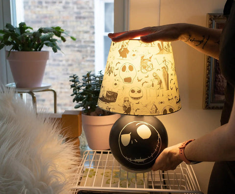 Nightmare Before Christmas Jack Skellington Table Lamp LED Light For Bedroom And Living Room on a desk with Halloween Town pattern.