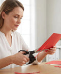 Laser Guided Scissors for Fabric and Paper Cutting, Infrared Laser Line, used on red paper by a woman in a light room