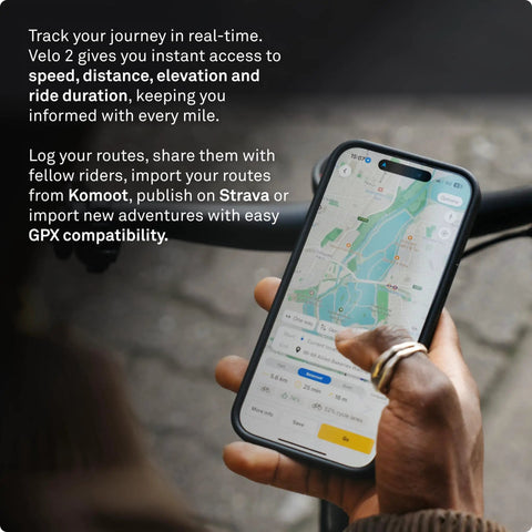 Person holding smartphone displaying Velo 2 Bike GPS Computer With Wireless Global Navigation For Cycling Weatherproof Build 11 Plus Hours