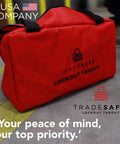 Heavy Duty Lockout Tagout Bag for LOTO Devices, red polyester canvas, industrial grade, with strong handles, on worksite floor.