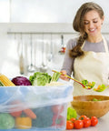 Woman using Clear Poly Meat Lug Liners Set, 25 Count, 21x22 Inch, 2.5 Mil Food Grade Tub Liners in kitchen with vegetables