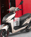 Waterproof Outdoor Outlet Box Cover For Charging Stations Featuring Hella Tough Pp Shield And Quick Install Setup To Keep Your Power Plugs Clean And Weather Ready Year Round mounted on a scooter.
