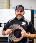 Man holding Copper Nickel Brake Line Coil 1/2 Inch By 25 Foot Non Magnetic Tubing For Automotive Use, Easy Bend and Flare