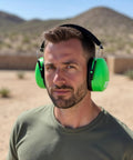 Person wearing Professional Safety Ear Muffs With 37 dB NRR For Shooting And Industrial Use outdoors