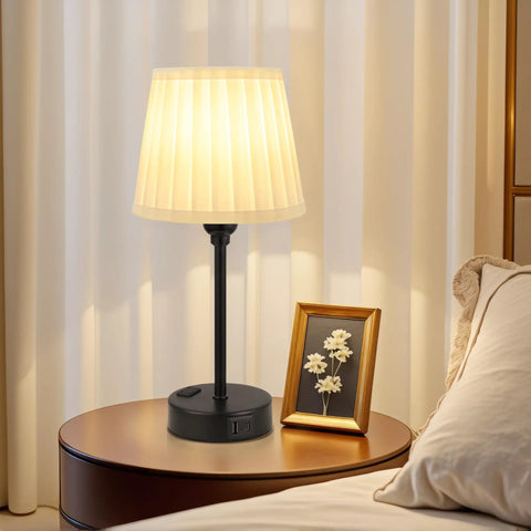 Two Pack Turquoise Bedside Lamps With USB C Port And AC Outlet Charging on a nightstand near a bed, lit with soft glow.