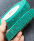 Home Run 8 Inch Green Non Woven Buffing And Polishing Wheels Pair held in hand, ideal for rust removal and polishing surfaces.