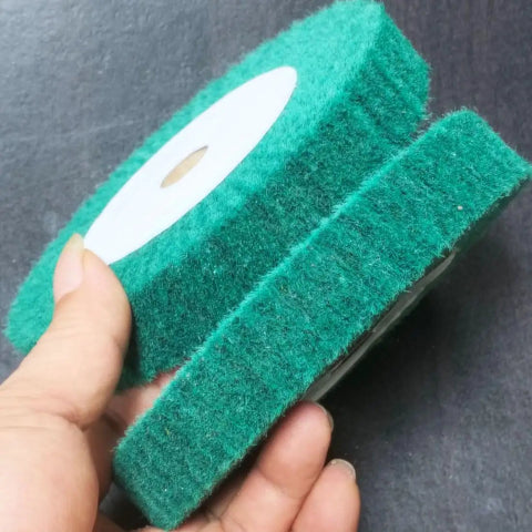 Home Run 8 Inch Green Non Woven Buffing And Polishing Wheels Pair held in hand, ideal for rust removal and polishing surfaces.