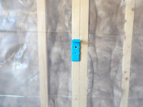 Drywall Buddy Tool Set Of 2 For Easy And Safe Wall And Ceiling Drywall Fitting And Support Built Tough With Durable ABS High Strength Plastic Pro Contractor Grade One Or Two Person Operation installed on a wooden stud.