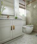 Modern bathroom with marble tiles and cabinets featuring antique brass cup pulls, showcasing elegant design and functionality.
