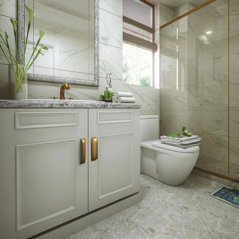 Modern bathroom with marble tiles and cabinets featuring antique brass cup pulls, showcasing elegant design and functionality.