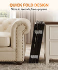 Extra Wide 60 Inch Free Standing Dog Gate For Home Doorways Rock Solid Metal Pet Fence folded against furniture.