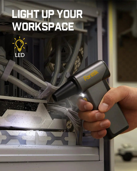 Hand using B10 Pro Max Cordless Electric Air Duster With 130000 RPM Brushless Motor to clean PC components with LED light in grey color.