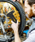 Cyclist using tension meter from 12 Piece Bicycle Spoke Tool Set With Tension Meter And Aluminum Alloy Wrenches to adjust wheel