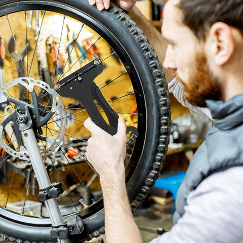 Cyclist using tension meter from 12 Piece Bicycle Spoke Tool Set With Tension Meter And Aluminum Alloy Wrenches to adjust wheel