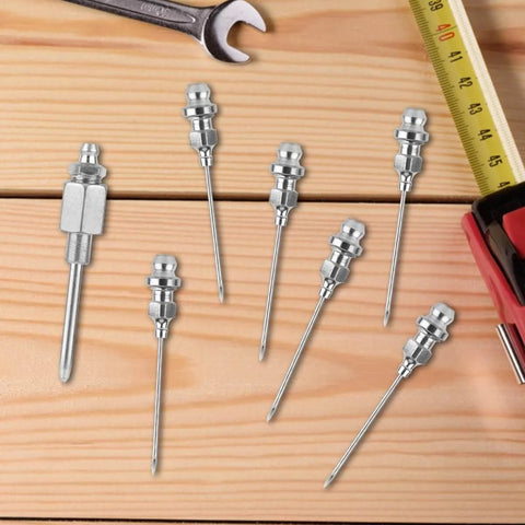 Grease Needle Gun Nozzle Kit With Six Nozzles And One Dispenser Hardened Steel Grease Injector Tool displayed on a wooden surface