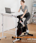 Woman using Compact Adjustable Standing Desk On Wheels For Home Office, Rolling Laptop Table with bike setup