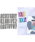 Shadow 26 Capital Letters Metal Cutting Dies For Card Making Kit with colorful card samples beside the die set.
