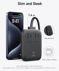 Road Tested Solid Power Brick And 67W Type C Charger Delivers PD Fast Charge With Six Outlets next to a smartphone, showing compact design.