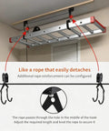 Dual Overhead Ladder Storage Hoist For Garage Or Shed Ceiling Pulley Lift System Holds 125 Lb And Fits Folding Telescoping Extension And Step Ladders Easy Install And Smooth Retrieval visible in use with ceiling mount and hooks