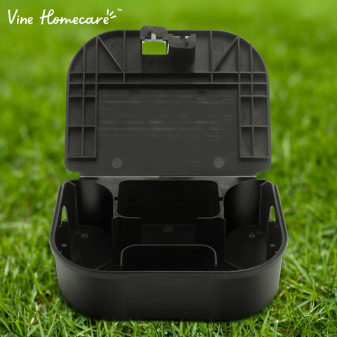 Heavy Duty Small Mouse Bait Stations With Secure Locks For Indoor Or Outdoor Pest Control And Discreet Rat And Mouse Bait Block Holders In A Practical 12 Pack Bundle To Kick Those Nasty Critters Out - open black bait station on grass.