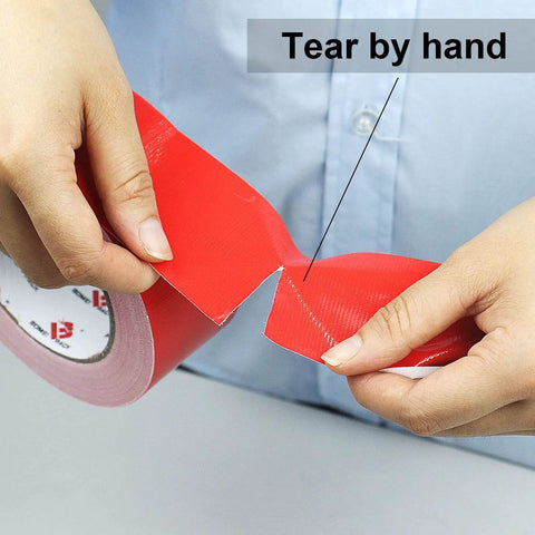 Two Pack Red Duct Tape Heavy Duty 9 Mil Thick 2 Inch By 30 Yard Roll being torn by hand, showing flexibility and ease of use.