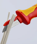 1,000V Insulated Cable Knife With Solid Fixed Blade cutting cable, red handle, plastic coated back to prevent short circuits, slip guard handle.