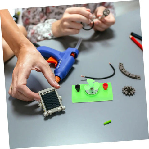 Hands assembling Solar Powered Science Experiment Kit For Kids With Mini Generator Motors Hand Cranked Wind Turbine Quiet Operation
