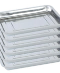Stack of shiny six pack stainless steel seed starter trays for germination seedlings and water collection nursery use