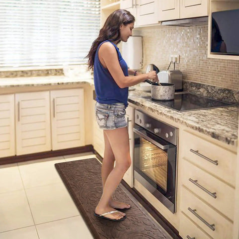 Woman standing on Ultra Plush Anti Fatigue Kitchen Mat Cushioned Comfort Rug With Waterproof Non Slip Surface in kitchen.
