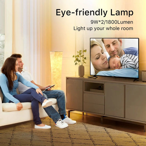 Couple with baby sitting in living room, 52 Inch RGB Color Changing Floor Lamp With Adjustable Brightness And Color Temperature lit behind.