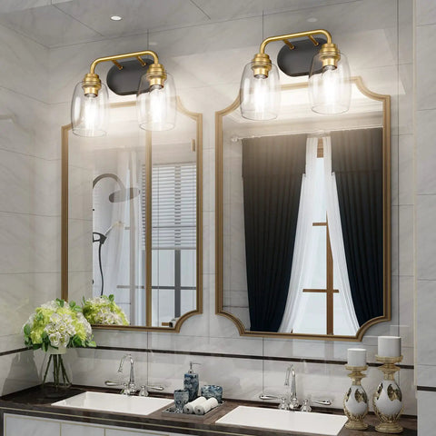 Two Light Sleek Industrial Black And Gold Vanity Light Fixture Over Mirror with clear glass shades in bathroom setting