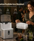 Top Tier Countertop Nugget Ice Maker Churns Out 35 Pounds Of Chewable Pebble Ice In Just Seven Minutes With Self Cleaning Design And Removable Basket For Everyday Chill Sessions In Silver, showing detachable ice basket in use.