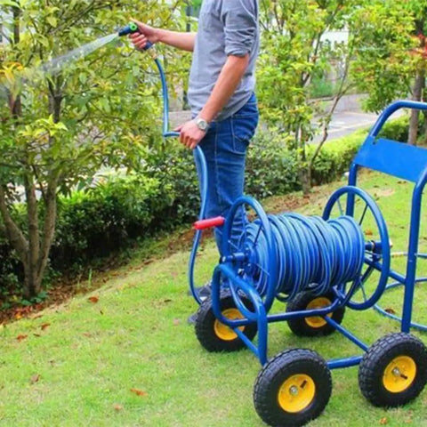 Heavy Duty Metal Hose Reel Cart With Smooth Rolling Wheels For The Backyard Boss Includes Flexible Garden Hoses in use.