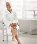 Woman seated on Shower Seat With Padded Arms And Removable Back for safe bathtub use, adjustable legs, wide chair