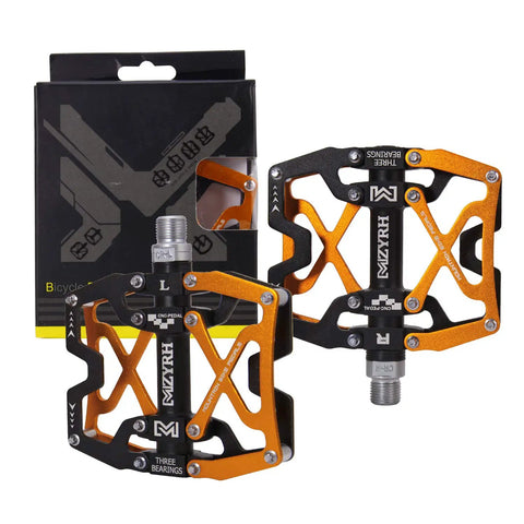 Nine Sixteenths Inch Mountain Bike Pedals With CNC Machined Body Sealed Bearing Platform Three Bearings Anti Slip Pins Ultra Strong And Lightweight Finish Colorful For Trail Or Race displayed with packaging