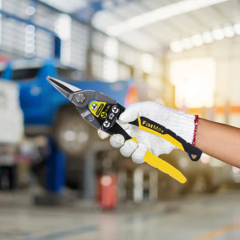 Person holding MaxSteel Straight Aviation Snips 9.84 Inch Heavy Duty Sheet Metal Cutters with black yellow handles in a workshop