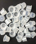 Large Tattoo Ink Cups 500 Pack Plastic Pigment Cups Size 15 Disposable Microblading Cups scattered on black surface