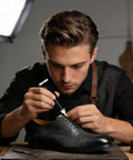 Man applying Leather Repair Cream For Furniture, Cars, Bags And Boots - Quick-Dry Liquid Pigment on black leather shoe
